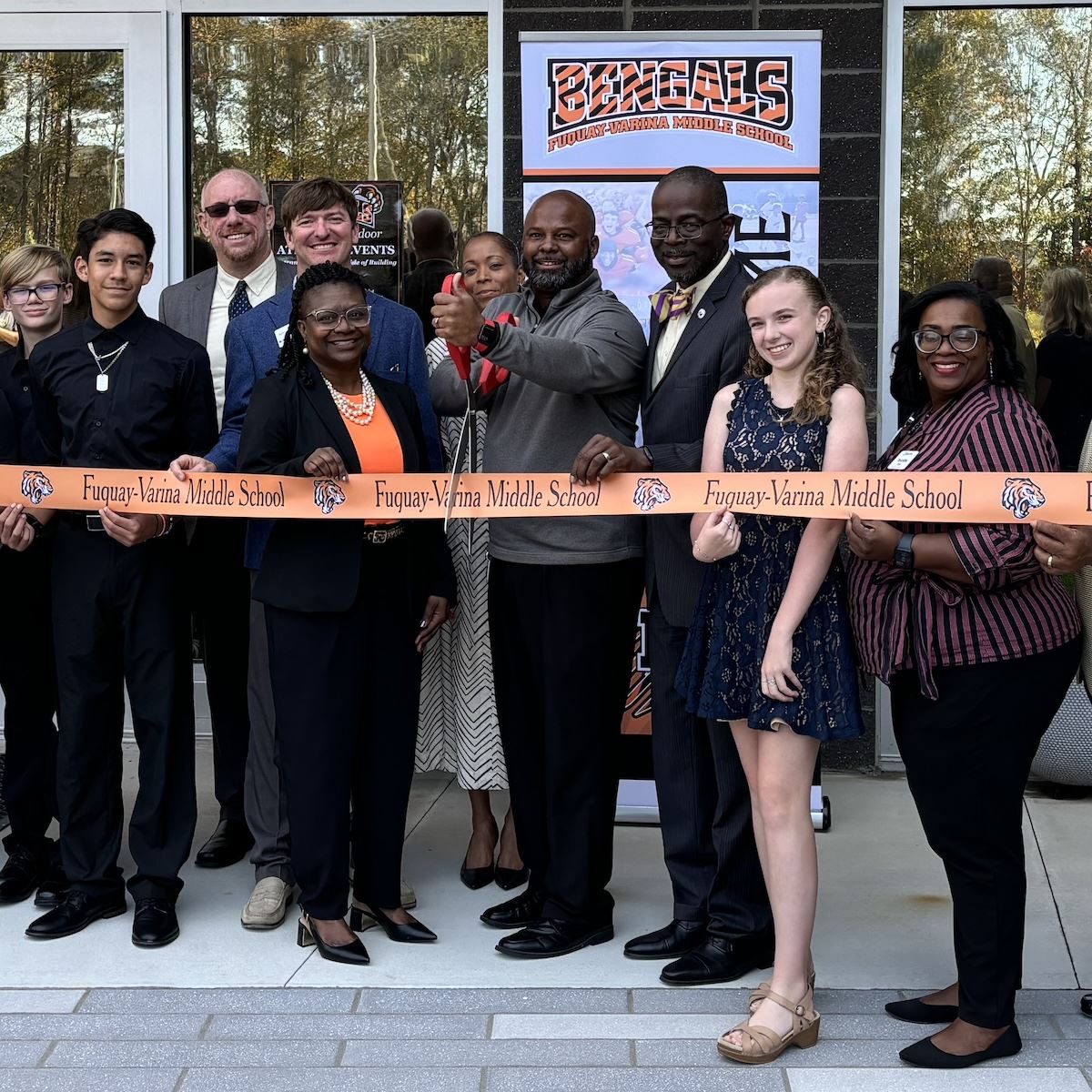  Principal Kris Clark cuts the ribbon alongside students and district leaders